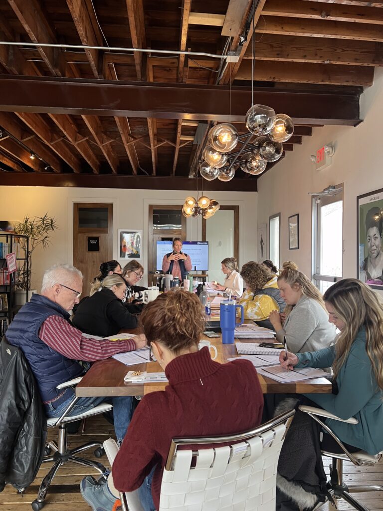 Holistic health practitioners collaborating at a muscle testing workshop.